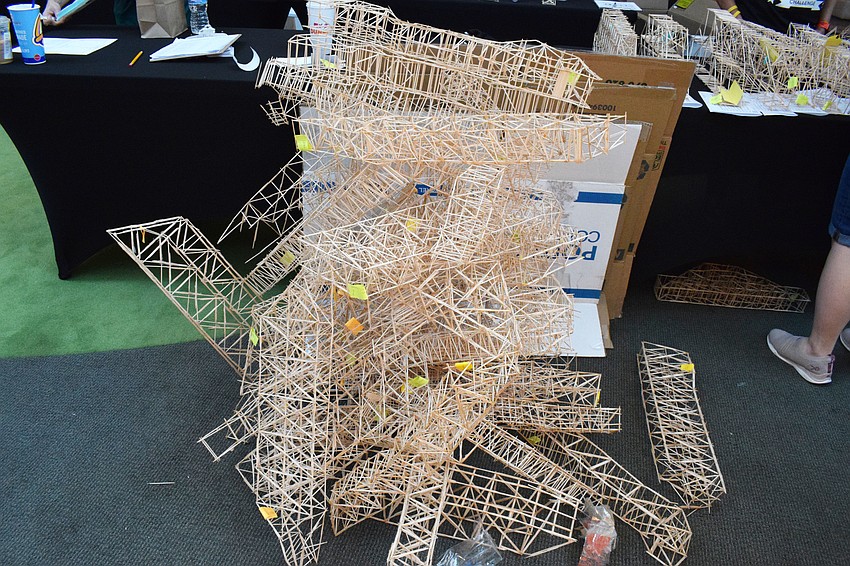 After students are done testing their bridges, they throw them in a pile to be completely destroyed.