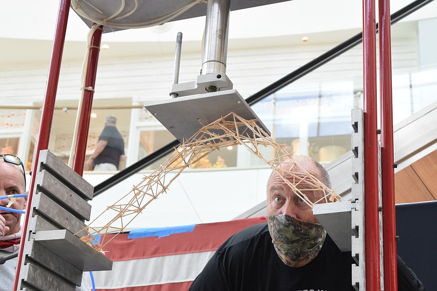 Volunteer Mike Elfers makes sure the bridge is secure before adding pressure.
