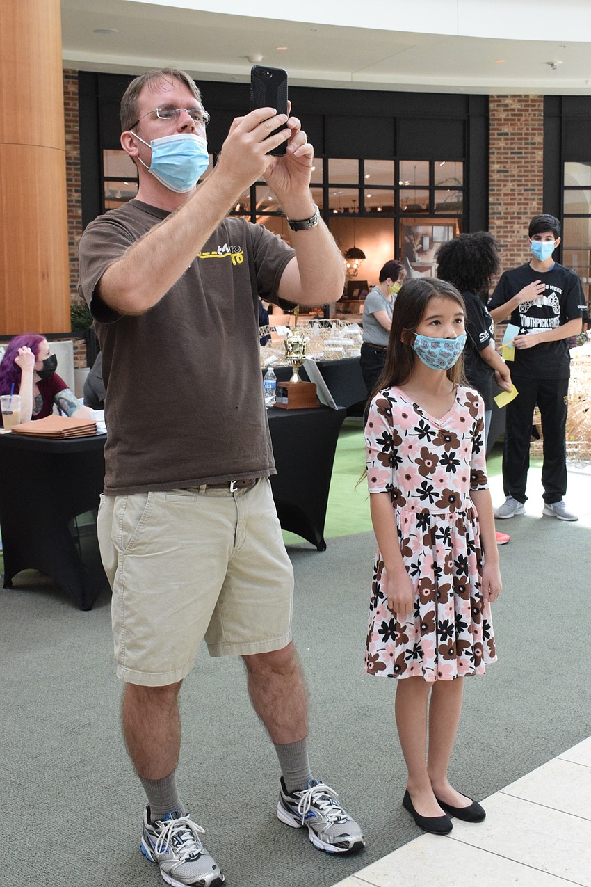 Bradenton's Nathaniel Hakes takes a video of his daughter Emma Hakes' bridge being tested.