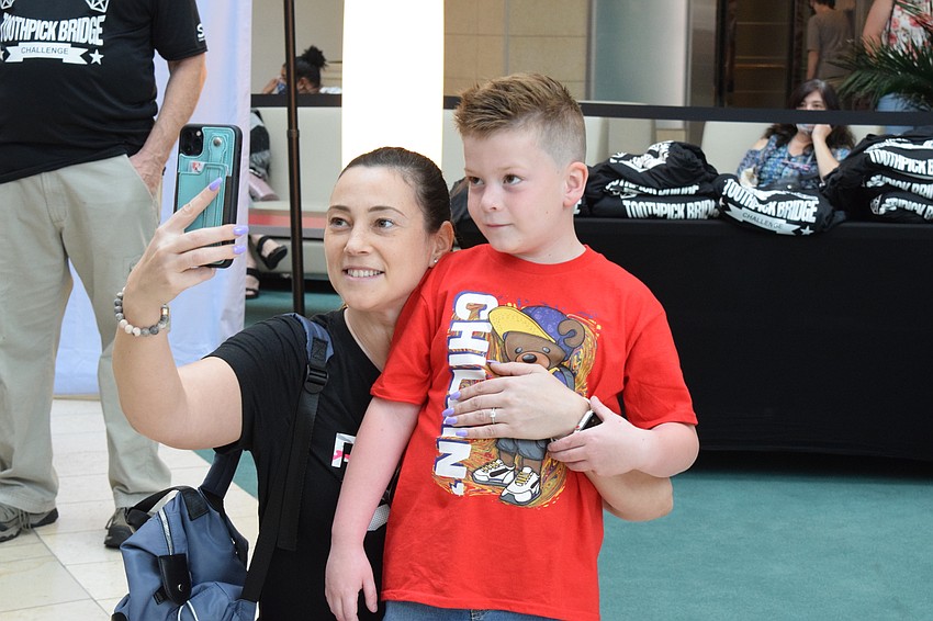 Sarasota's Val Warren and her son Jossiah Warren, who is 6, watch in amusement as a bridge takes on more and more pressure before breaking.
