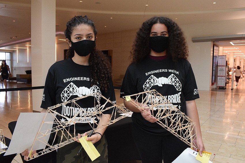 Maria Becerra, a freshman at Suncoast Polytechnical High School, and Kamryn Barker, a sophomore at the school, wait in line to have their bridges tested.