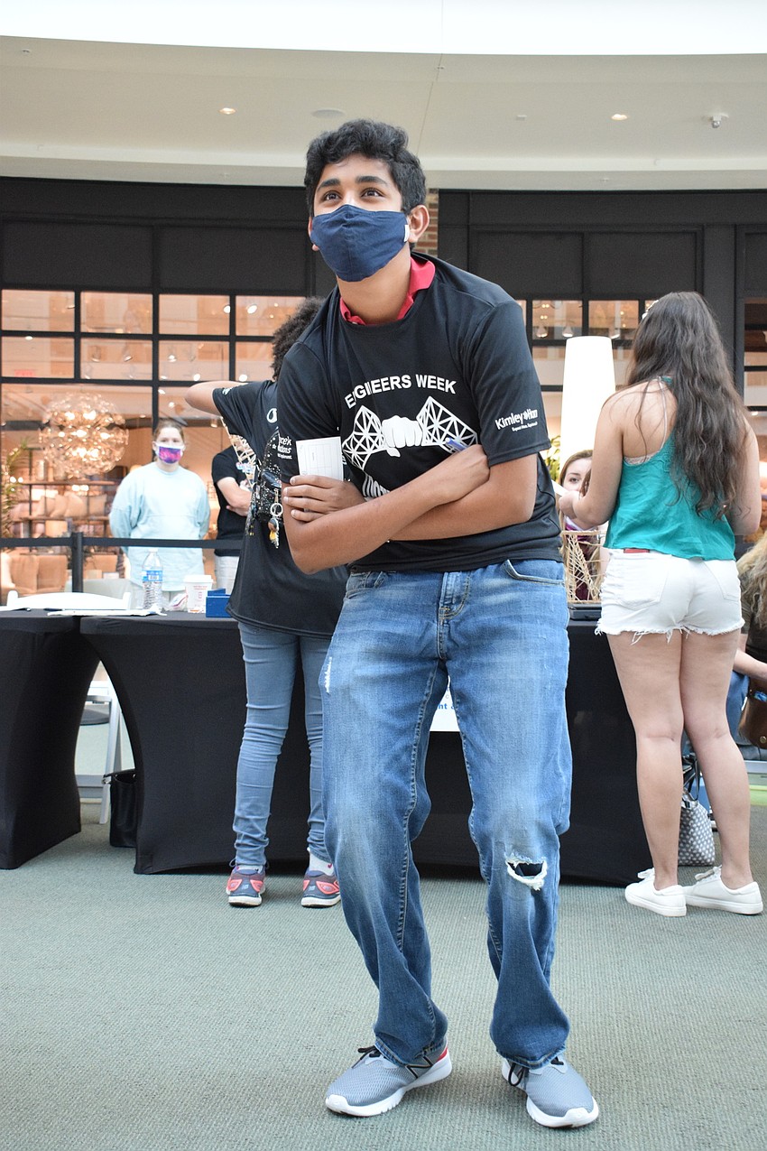 Om Patel, a sophomore at Sarasota High School, watches in amazement as his bridge holds more than 40 pounds of pressure. He was expecting his bridge to break after 20 pounds.