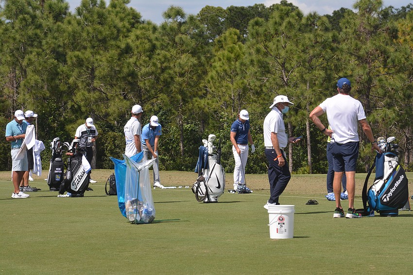 Golfers at the World Golf Championships-Workday Championship at The Concession practice on the driving range before their rounds.