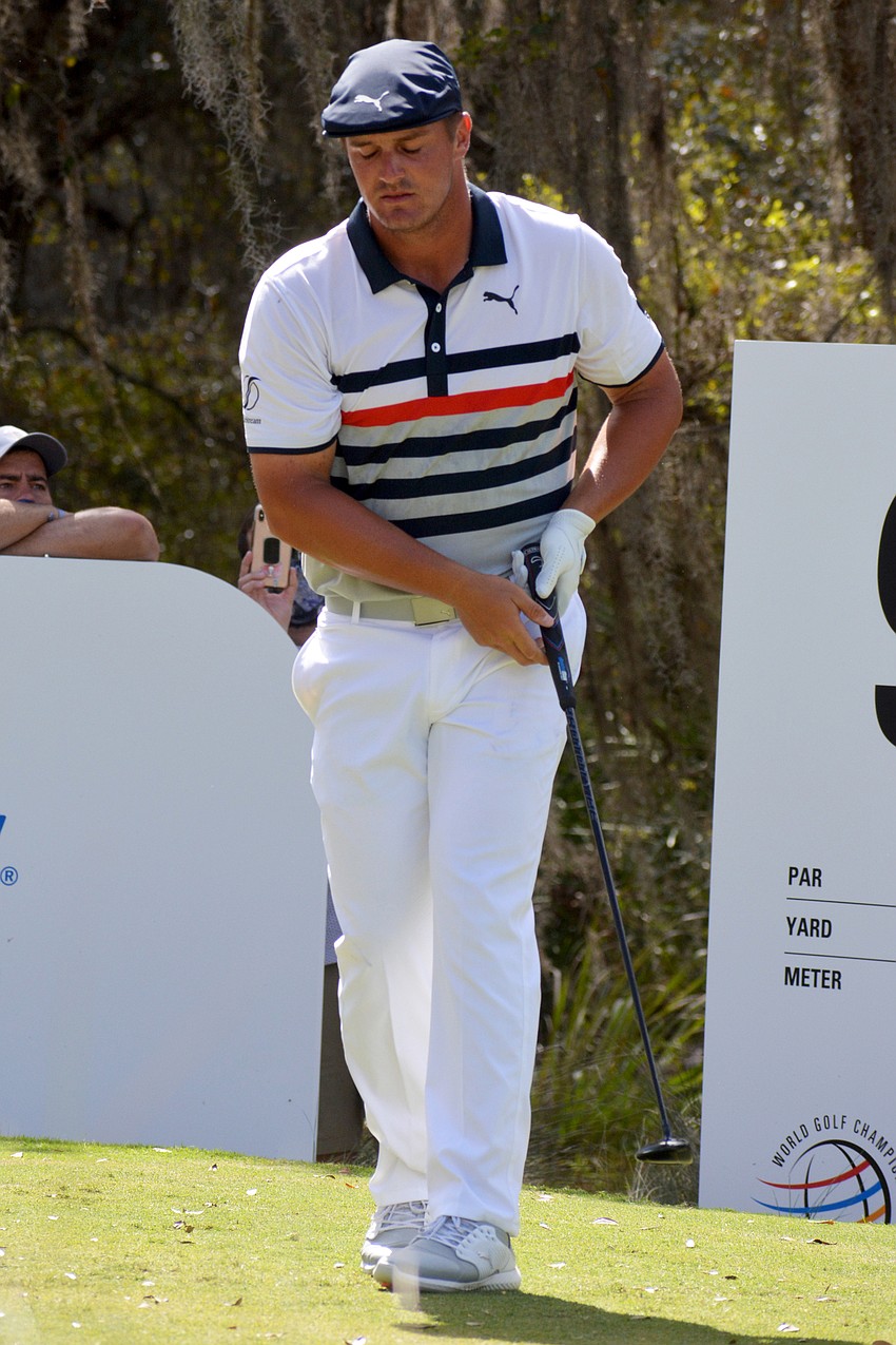 Bryson DeChambeau closes his eyes after hitting his tee shot on the No. 9 hole at The Concession Golf Club. Despite his reaction, DeChambeau would birdie the hole. He shot even par for the round and is three under par overall.