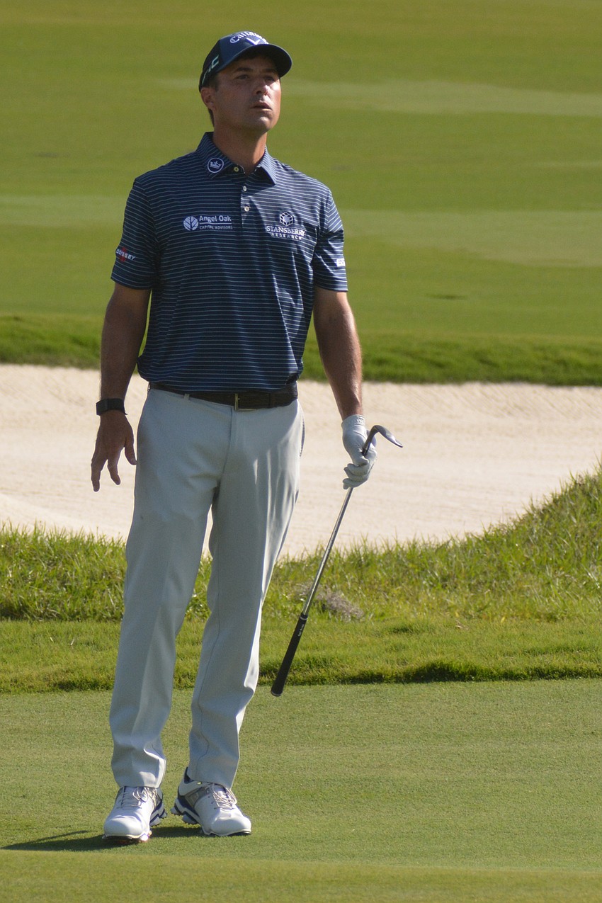 Kevin Kisner attempts to stretch and watch his chip shot on the No. 12 hole at The Concession Golf Club. Kisner would double bogey the hole.