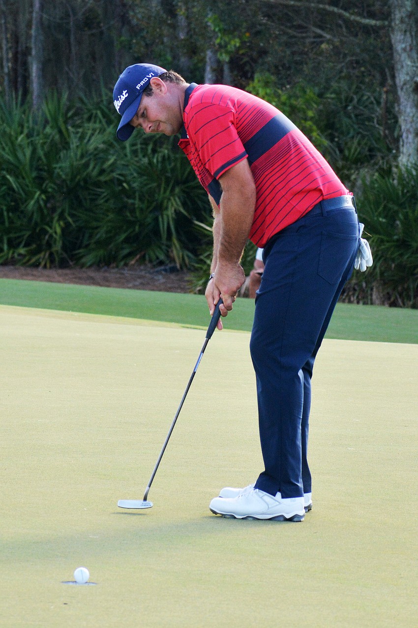 Patrick Reed sinks a birdie putt on the No. 12 hole at The Concession Golf Club.