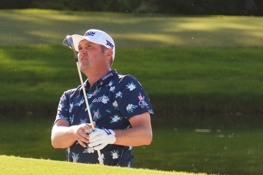 Jason Kokrak watches his chip shot on the No. 18 hole at The Concession Golf Club. Kokrak would bogey the hole to finish the round three under par. He is eight under par overall.