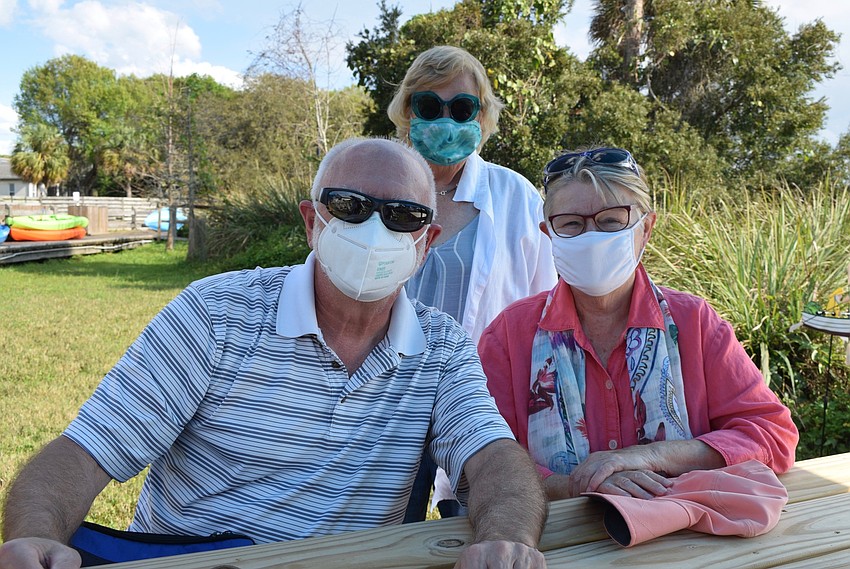 Venice's Ann Hogg gets to know East County's Duane and Nancy Stasiewicz when they are seated at the same picnic table to watch the play.