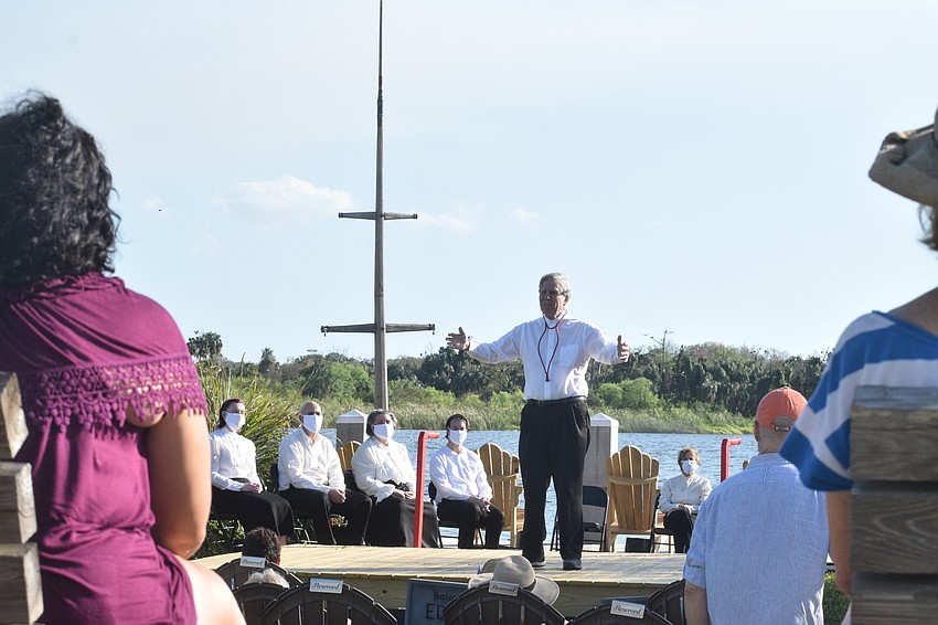 Audience members listen intently as actors come on stage one-by-one in 