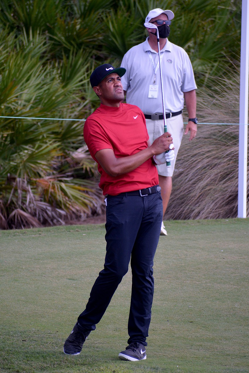 Tony Finau hits a high chip shot on the No. 12 hole at The Concession Golf Club. Finau would par the hole.