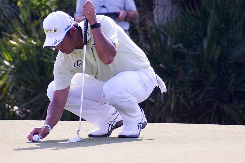 Hideki Matsuyama sets his ball on the No. 12 green at The Concession Golf Club. Matsuyama would par the hole. He finished the tournament eight under par.