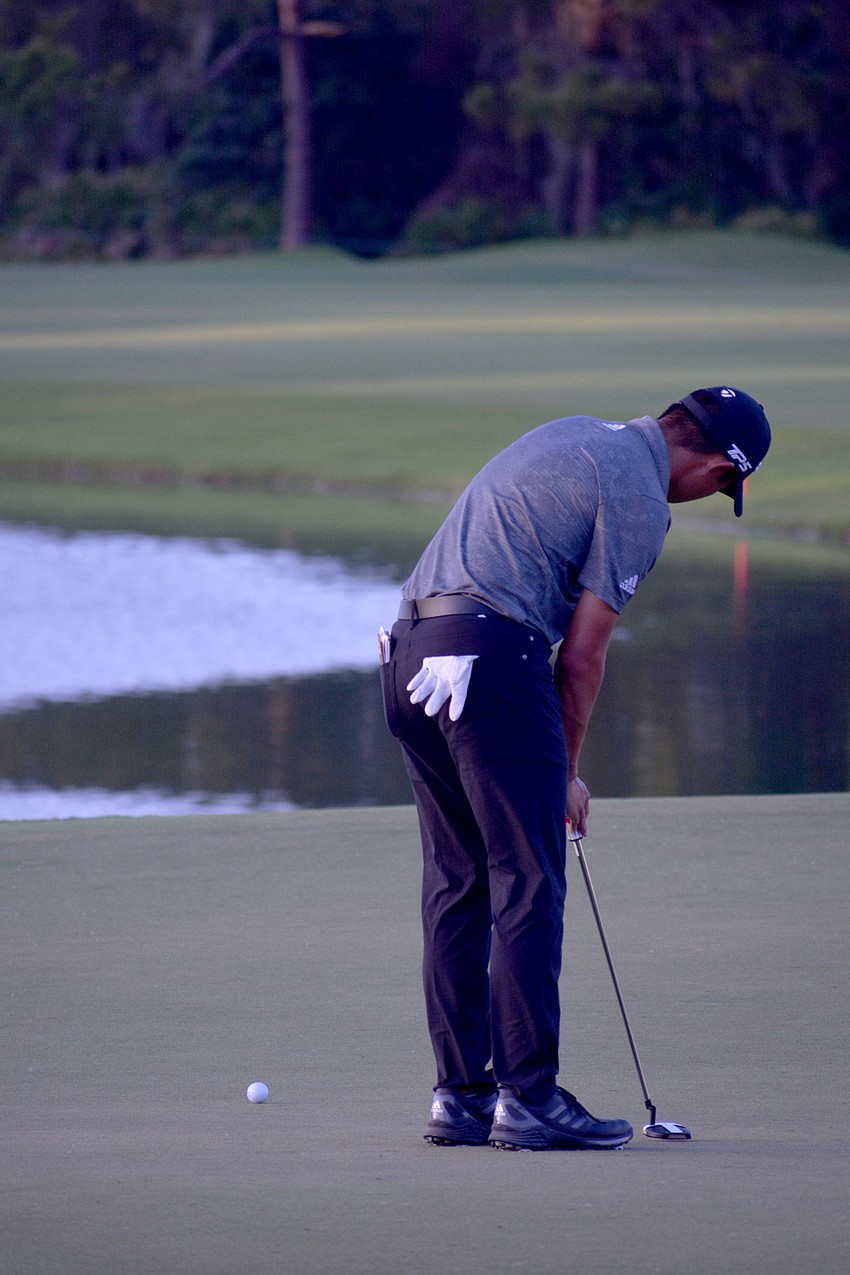 Collin Morikawa putts for par — and the win — on the No. 18 green at The Concession Golf Club.