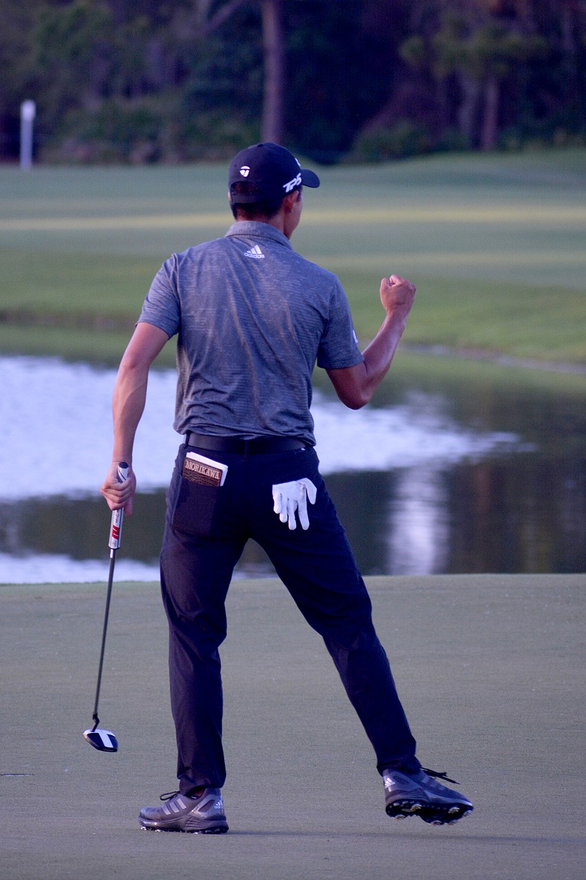 Collin Morikawa pumps his fist at his caddie after winning the World Golf Championships-Workday Championship at The Concession.