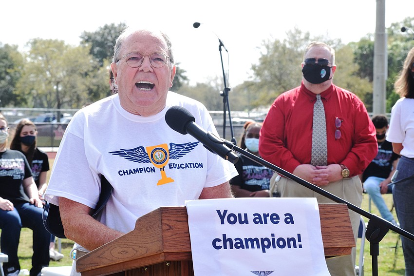 John Harder, a retired teacher and Hall of Fame Coach, has the employees chant 