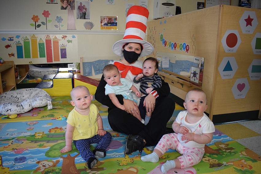 Dressed as the Cat in the Hat, Mariah Esparza visits Peyton Kropidlowski, Oliver Bailey, Ethan Sanchez and Kinley Larson.