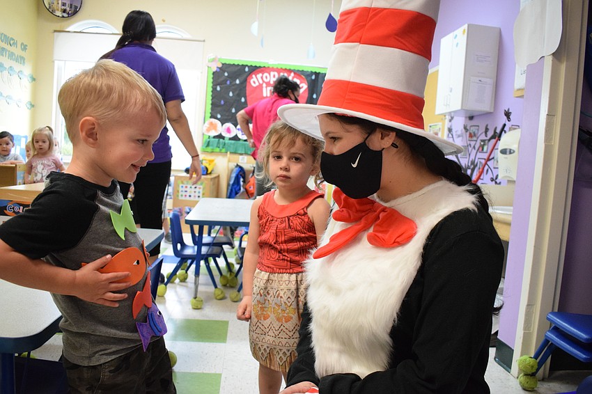Chase Slepokura shows off his Dr. Seuss themed shirt to Mariah Esparza, a teacher dressed as the Cat in the Hat.