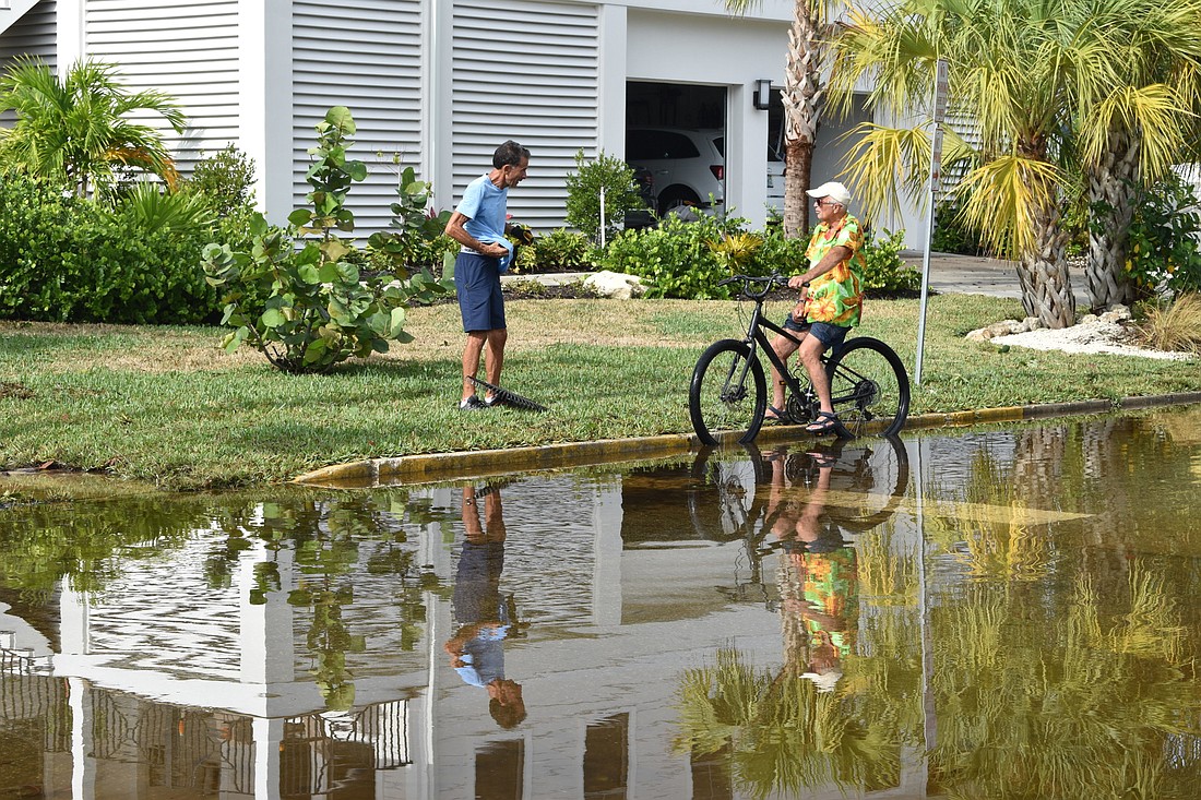 Tropical Storm Eta brought flooding to many parts of Longboat Key. Here Longbeach Village neighbors John DeVito (left) and Fred Kagi  (right) chat outside their homes in November 2020.