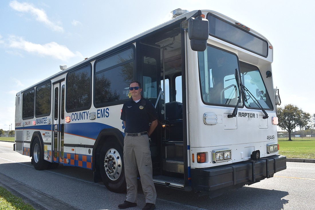 Deputy Chief Sean Dwyer stands with the RAPTOR 1, a converted Manatee County Area Transit bus now used as an ambubus.