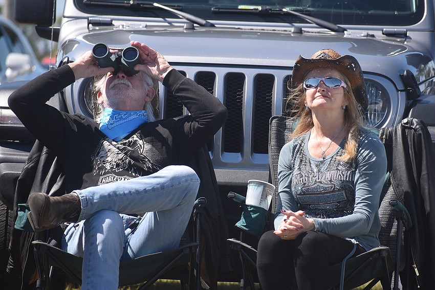 Myakka residents Albert Noe and Theresa Delaney watch Galaxy Girl balance on a pole 127 feet above the ground. Noe once wrote a song for Nik Wallenda called 