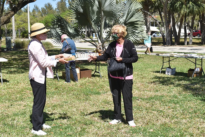 Susan Jones accepts payment for Peggy Kostelnik's books.