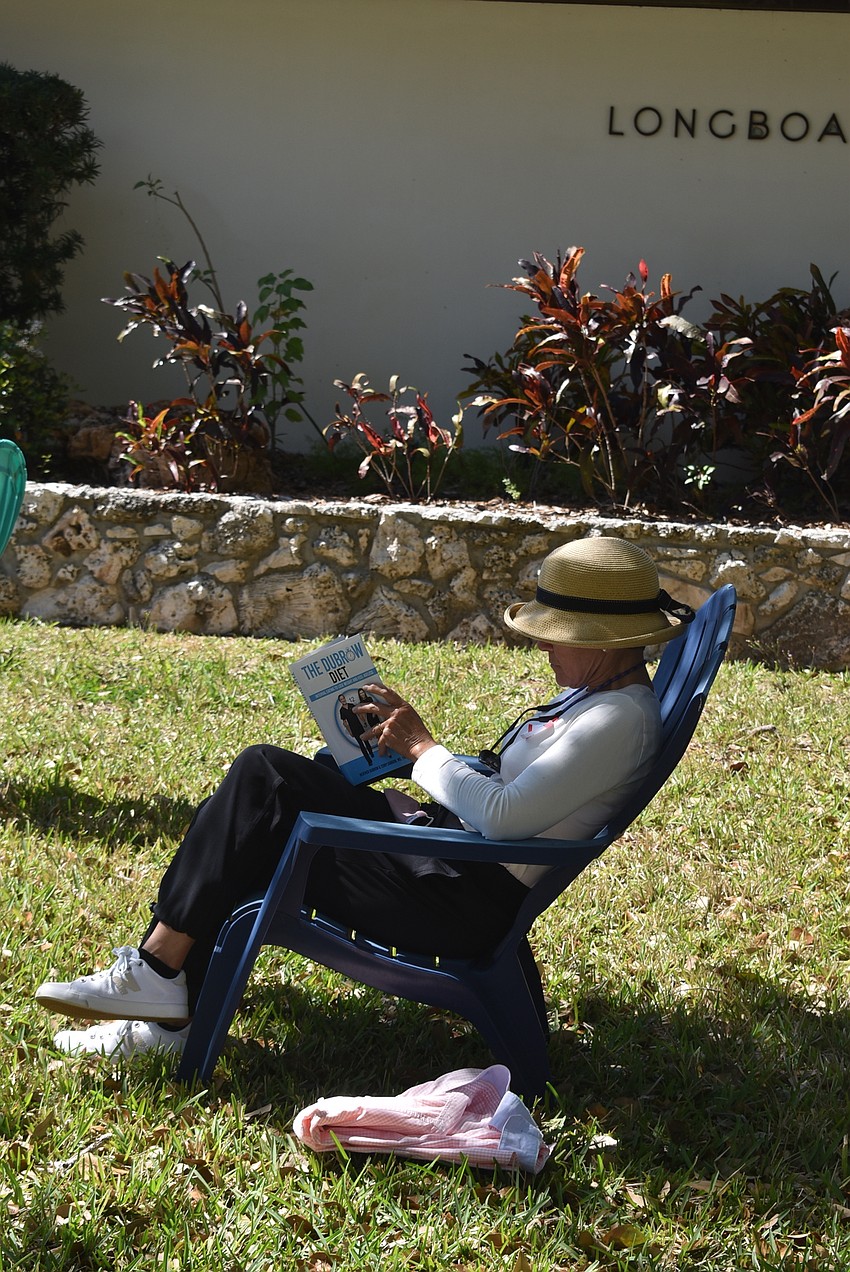 Volunteer Susan Jones takes  abreak with a book she found.
