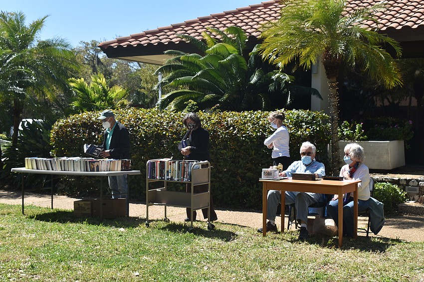 Volunteers manned the payment station and answered questions about the library's imminent reopening.