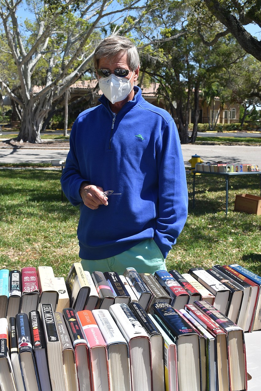 Philip Deming browses the biography section.