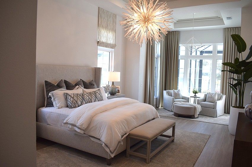 The Clairborne's master bedroom features artistic lighting and a sitting area.