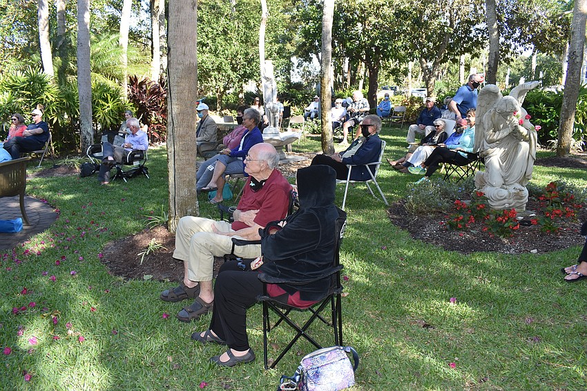Attendees spread out along the church meditation garden.