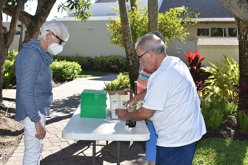 Joann Vinci waits for a glass of wine poured by Wahib Habib.