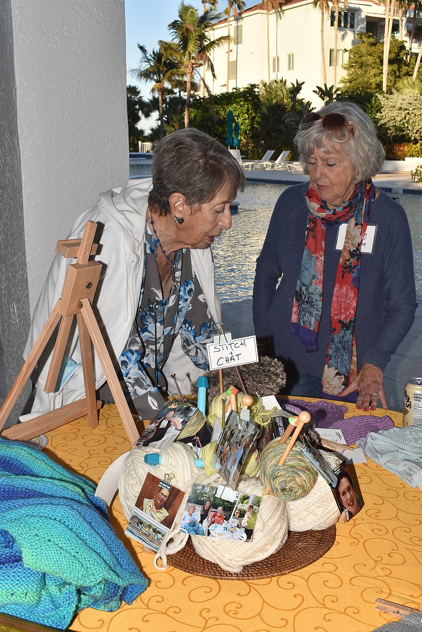 Rhoda Cooper and Bonney Libman admire their neighbors' stitching.