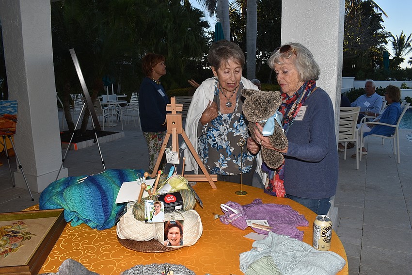 Rhoda Cooper and Bonney Libman admire their neighbors' stitching.