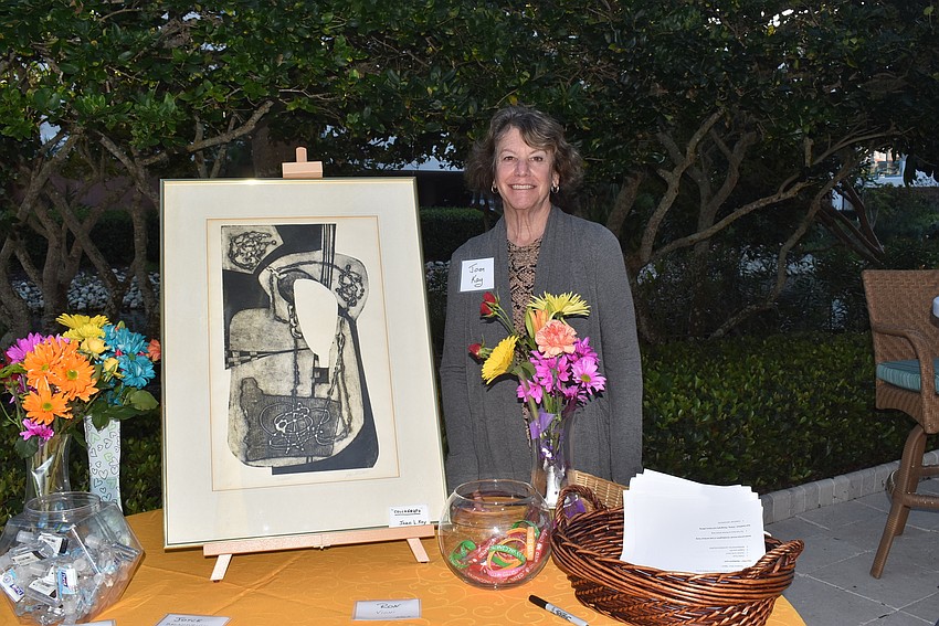 Joan Kay with her art piece at the welcoming table.