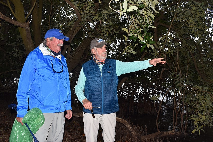 Rusty Chinnis, right, shows Mike Haycock the lay of the land on the Sister Keys.