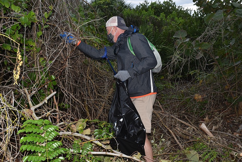 Jay Hart searches for trash.