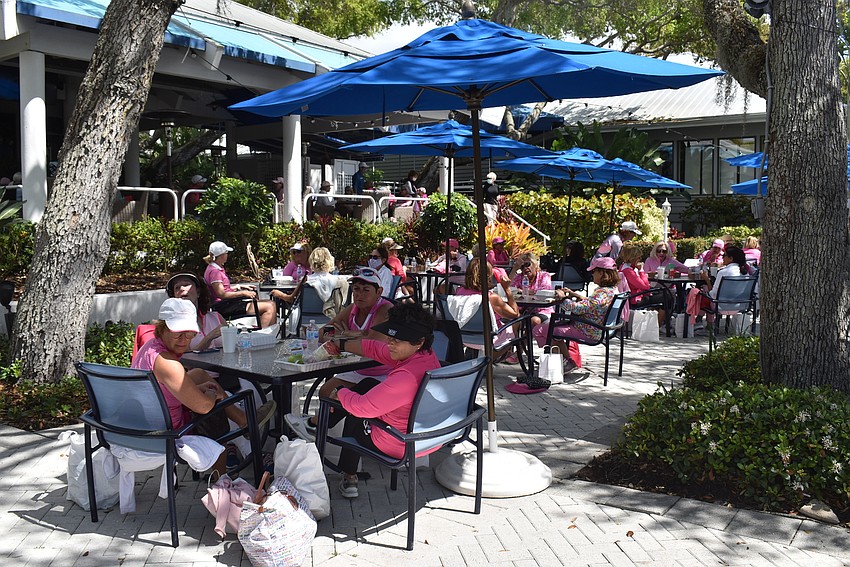 The golfers were divided into groups of four, which they stayed with for their brief outdoor lunch.