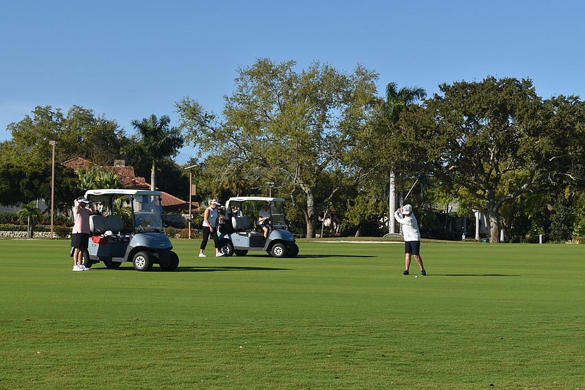 Jan Van Iten takes a swing to start her round of golf.