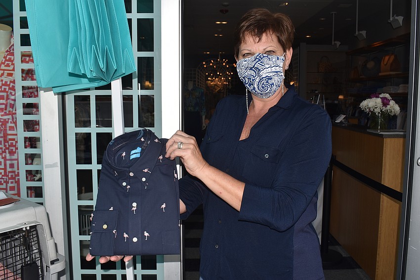 Melanie Dale shows off a newly delivered shirt with flamingoes.