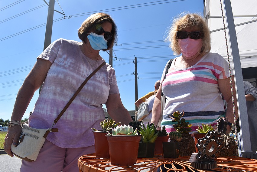 Carolina Landings resident Gloriann Bronson and Palma Ranch resident Lil Pugliese look at cacti. The market was one of the first public events they've attended during the COVID-19 pandemic. They were both vaccinated recently.