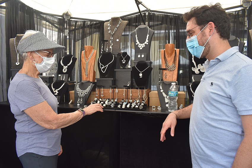 Colonial Grand resident Helen Hammerman talks with Tampa-based jewelry vendor Emre Tekeli. Hammerman said she was especially interested in Tekeli's 