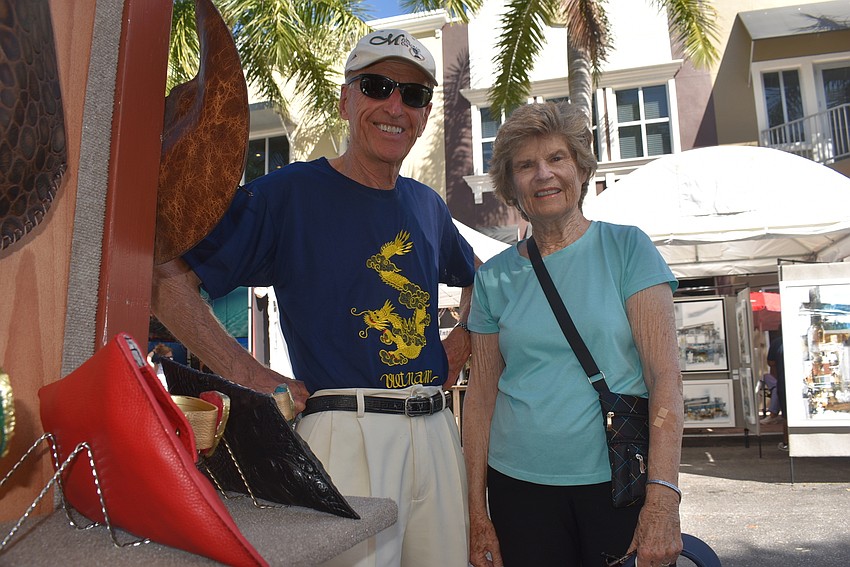 Edgewater Village residents Cliff and Julie Phalen stand outside Sulay Leather Bags. 