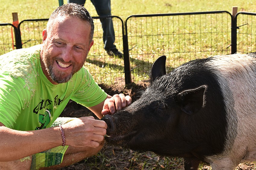 Todd Richardson, the principal, fulfills his promise to kiss a pig if the school raises $30,000. The school raised nearly $70,000. Courtesy photo.