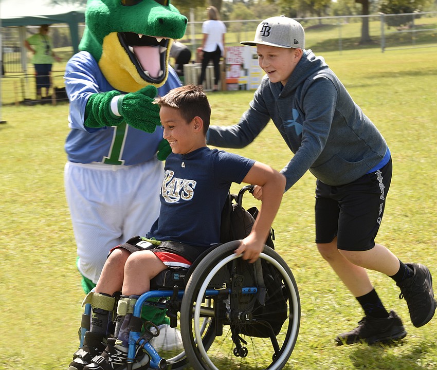 Sixth graders Bryce Santoro and Lex Duis make their way around the field during the walk-a-thon.