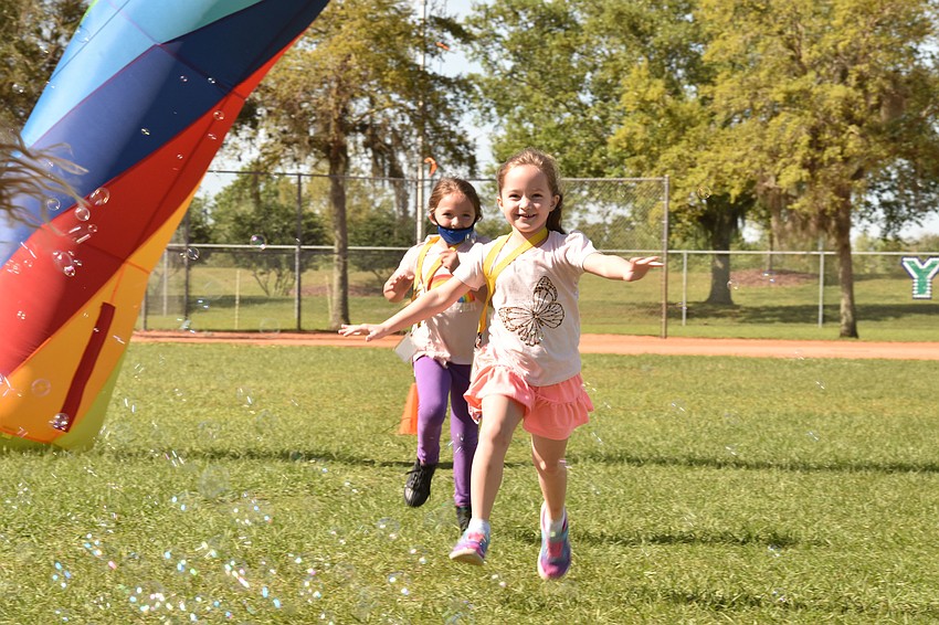 Lyla Sherwin runs behind Lilly Sommers during the walk-a-thon. The school's walkathon raised nearly $70,000.