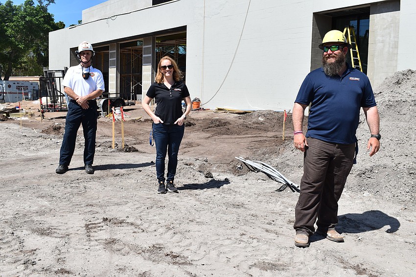 Fire Chief Paul Dezzi, Jon F. Swift Construction marketing and operations director Emmalee Legler and Jon F. Swift Construction superintendent Shane Hamm pose outside of the construction site of Fire Station 92 at 2162 Gulf of Mex