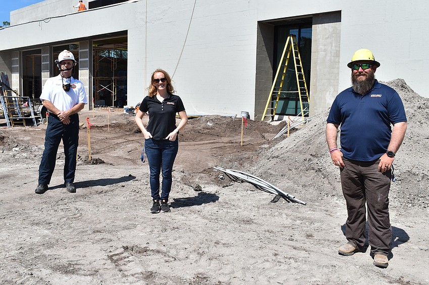Fire Chief Paul Dezzi, Jon F. Swift Construction marketing and operations director Emmalee Legler and Jon F. Swift Construction superintendent Shane Hamm pose outside of the construction site of Fire Station 92 at 2162 Gulf of Mex