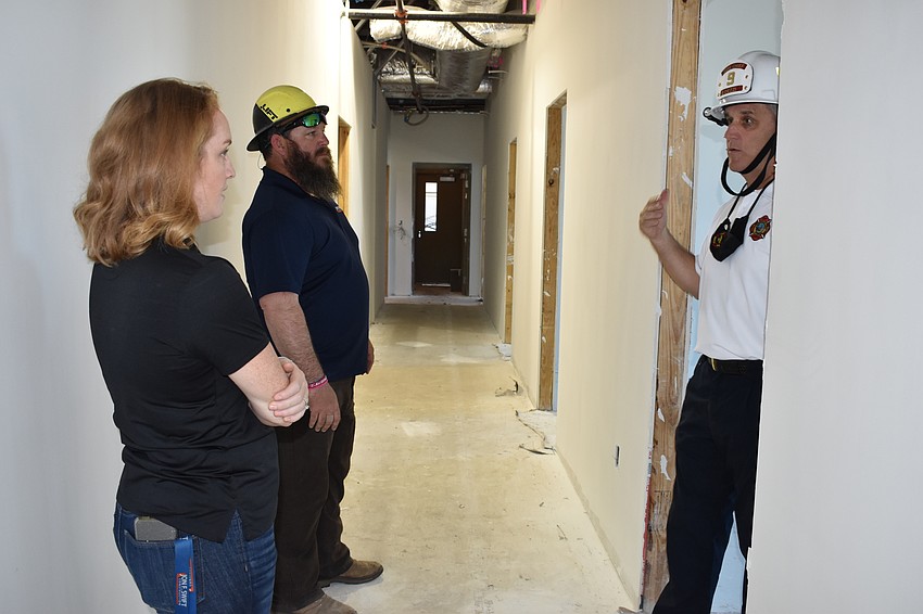 Fire Chief Paul Dezzi, Jon F. Swift Construction marketing and operations director Emmalee Legler and Jon F. Swift Construction superintendent Shane Hamm discuss the construction of Fire Station 92.