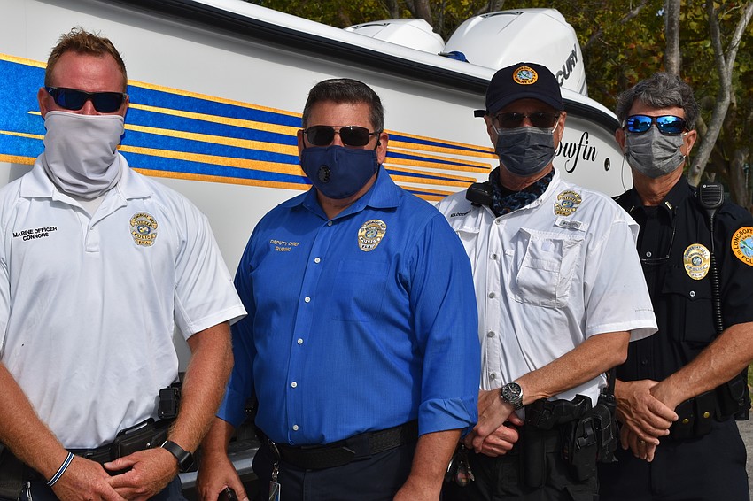 Marine patrol officer Joshua Connors, Deputy Chief Frank Rubino, marine patrol officer Ed Kolodzieski and police officer Chris Skinner pose in front of the police department's new boat.