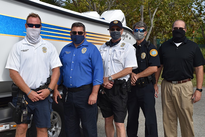 Marine patrol officer Joshua Connors, Deputy Chief Frank Rubino, marine patrol officer Ed Kolodzieski, police officer Chris Skinner and Town Manager Tom Harmer pose in front of the police department's new boat.