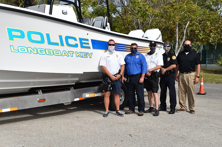 Marine patrol officer Joshua Connors, Deputy Chief Frank Rubino, marine patrol officer Ed Kolodzieski, police officer Chris Skinner and Town Manager Tom Harmer pose in front of the police department's new boat.